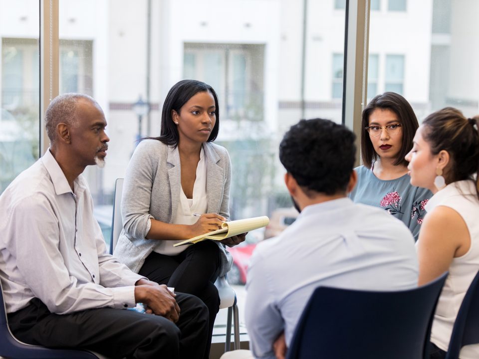 An Employee Assistance Program may include group therapy, as depicted in this image, as well as substance abuse counseling, fitness programs, and more.