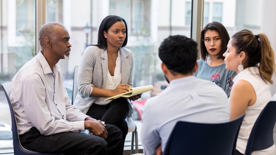 An Employee Assistance Program may include group therapy, as depicted in this image, as well as substance abuse counseling, fitness programs, and more.